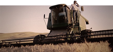 Worker on top of agriculture machinery