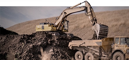 Construction machine picking up dirt