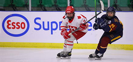 Image of women playing hockey.