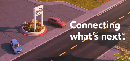 An animated Esso station is seen from above. Two cars are pulling out from the station heading in opposite directions.